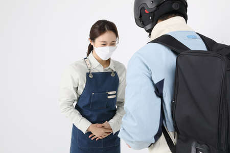 Asian Korean young man and woman startup concept_a delivery boss and a young man delivering a part-time jobの写真素材