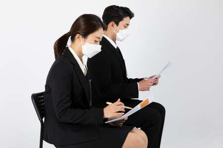 Asian Korean young generations woman and man job interview concept_Wearing a mask and preparing for an interviewの写真素材