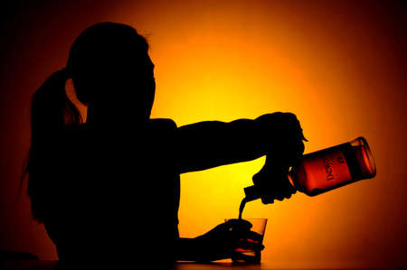 Woman pouring whiskey from a bottle