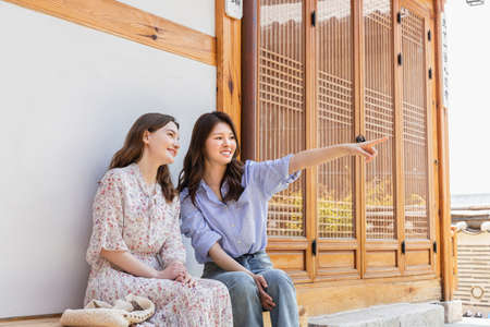 Experience Hanok, Korean traditional house, Korean and Caucasian girls looking at the landscapeの写真素材