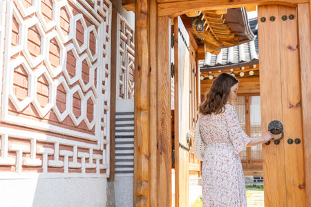 Experience Hanok, Korean traditional house_caucasian girl opening the doorの写真素材