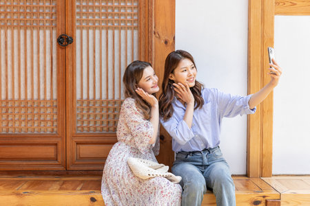 Experience Hanok, Korean traditional house_Korean and Caucasian girls taking a photoの写真素材