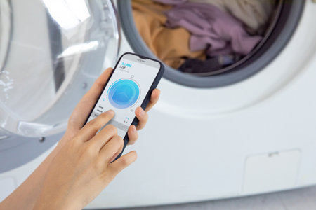 aesthetic laundry concept_Connecting washing machine app with mobile phoneの写真素材