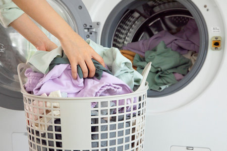 aesthetic laundry concept_Putting laundry into the washing machine