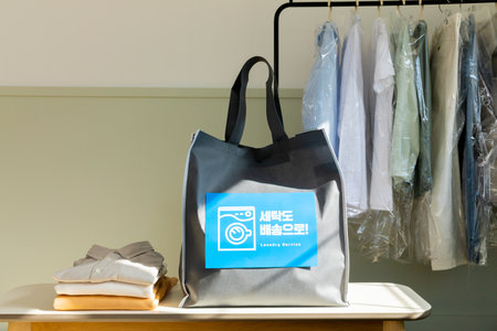 aesthetic laundry concept_laundry bag for pick up service with clothes rack background
