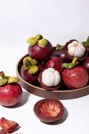 Tropical Fruits _Wooden plate and mangosteenの写真素材