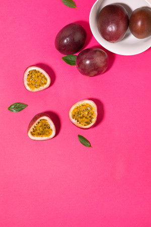Tropical Fruits_ White plate and passionfruitの写真素材