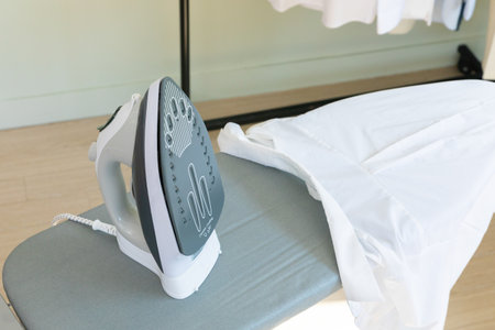 aesthetic laundry concept_clothes hung on a hanger and ironの写真素材