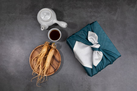 oriental, medicinal root plant, fresh ginseng wrapped in silk cloth for giftの写真素材