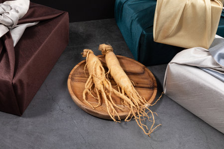 oriental, medicinal root plant, fresh ginseng wrapped in silk cloth for giftの写真素材