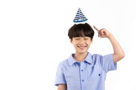 Korean young boy wearing summer blue half sleeve shirt in white background studio_toy sheep on top of headの写真素材