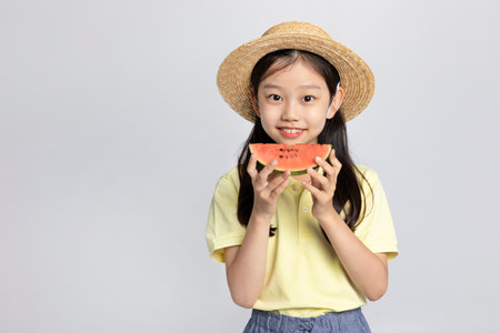 Korean young girl wearing gym clothes in white background studio__holding a watermelonの写真素材