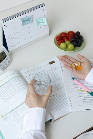 studying at home, study desk setup_taking supplements while studyingの写真素材