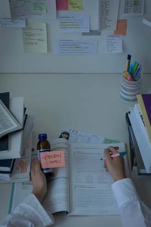 studying at home, study desk setup_stacked workbooks and invigorating drinkの写真素材