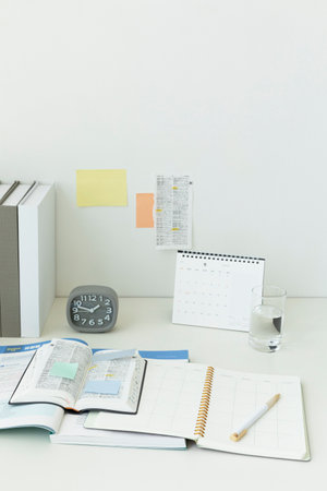 studying at home, study desk setup_studying dictionaries and workbooksの写真素材