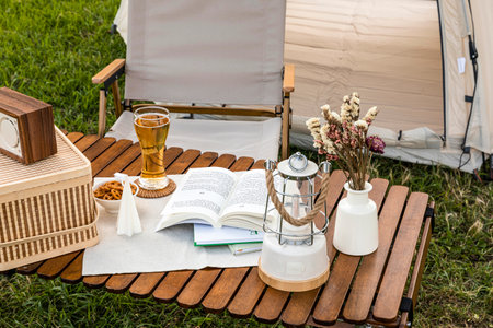 camping mood aesthetics_drinking beer with reading a bookの写真素材