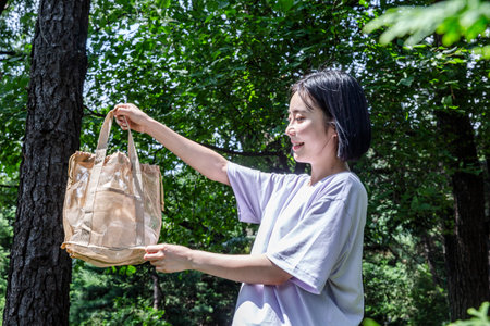 korean young woman hiking and plogging__picking up litter, garbage