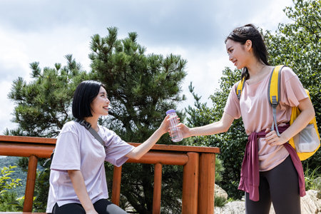 korean young women hiking and plogging-handed water bottle