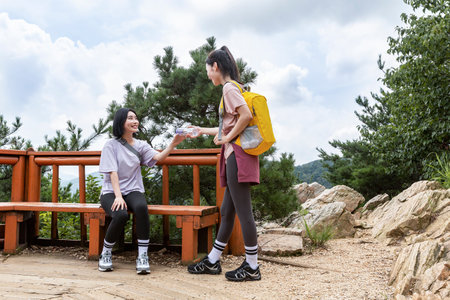 korean young women hiking and plogging-handed water bottleの写真素材