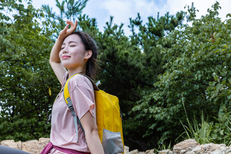 korean young women hiking and plogging- resting