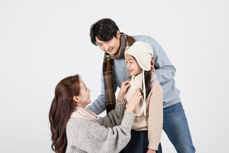 happy Asian Korean family, isolated in white background--in winter fashion, wearing muffler