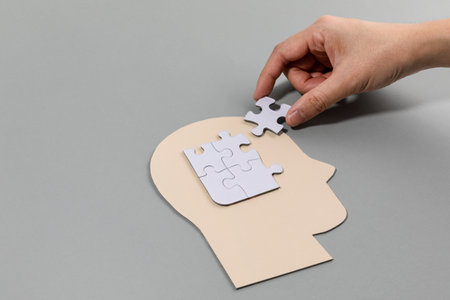 brain health and dementia series, holding the puzzleの写真素材