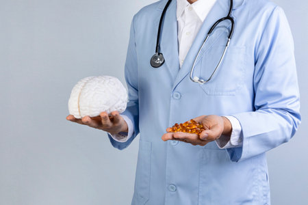 brain health and dementia series, doctor holding brain miniature and omega 3の写真素材