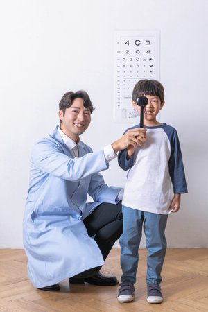 korean asian child in ophthalmic clinic, eyesight test