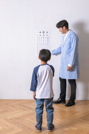 korean asian child in ophthalmic clinic, eyesight testの写真素材