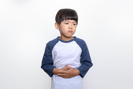 Asian Korean child suffering from stomachacheの写真素材