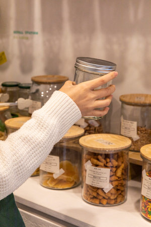 eco friendly habits hand gesture_refill station with empty bottleの写真素材