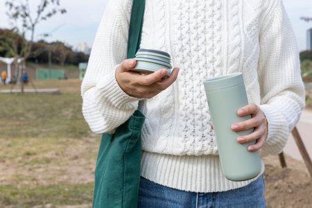 eco friendly habits hand gesture_holding a tumbler