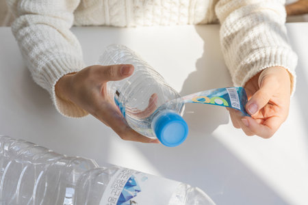 eco friendly habits hand gesture_remove the bottle labelの写真素材