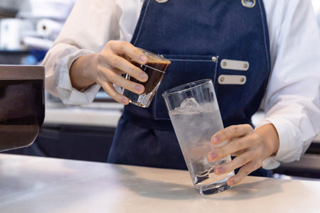 barista making, preparing coffee in cafeの写真素材