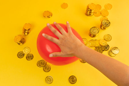 conceptual creative photo of monetary inflation, economic recession, crisis_pressing hands and coinsの写真素材