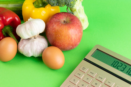 conceptual creative photo of monetary inflation, economic recession, crisis_vegetables and calculatorsの写真素材