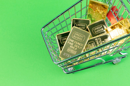 conceptual creative photo of monetary inflation, economic recession, crisis_shopping cart with a gold barの写真素材