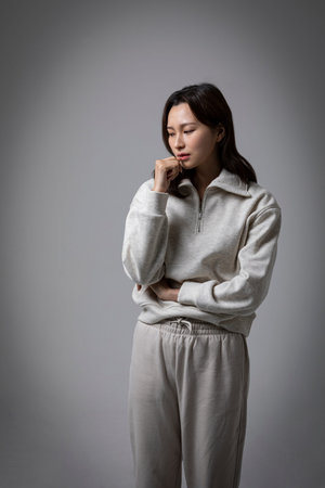 stressed, depressed Korean business woman in pink suit, worrying