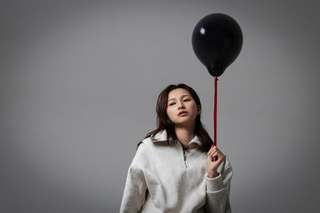 stressed, depressed Korean business woman in pink suit, worryingの写真素材