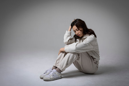 stressed, depressed Korean business woman in pink suit, frustratedの写真素材