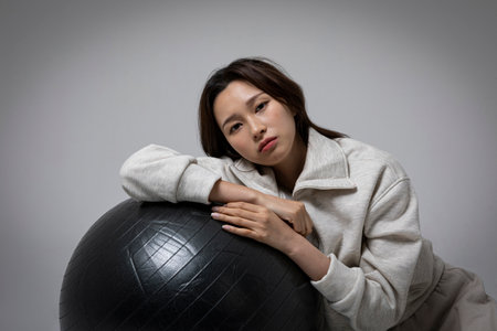 stressed, depressed Korean business woman in pink suit, frustratedの写真素材