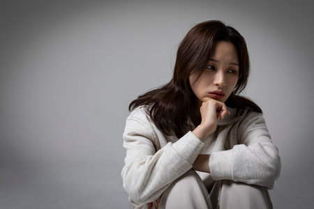 stressed, depressed Korean business woman in pink suit, worryingの写真素材