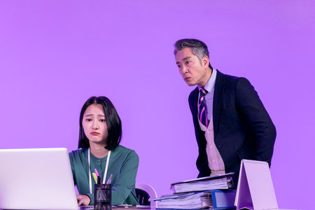 relationship and conflict between younger and older workers concept, Korean Asian young woman and manager level older manの写真素材