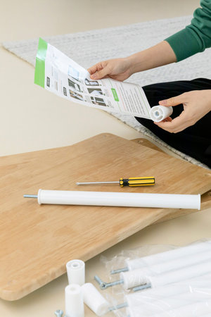 DIY interior hand motion, closeup_looking at the furniture manual
