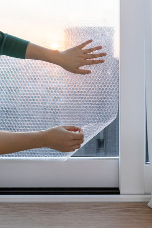 DIY interior hand motion, closeup_putting an air cap on the window