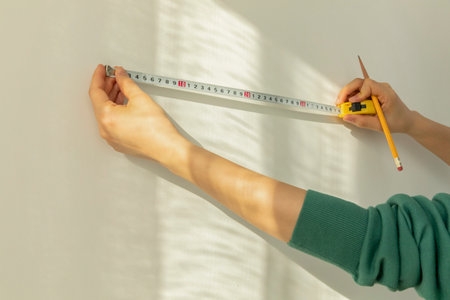 DIY interior hand motion, closeup_wallpaper length measurementの写真素材