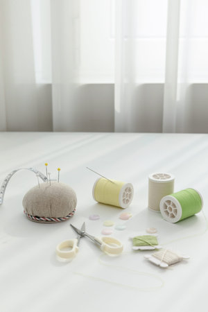 aesthetic photo of handmade, crafting hobbies, thread, button, needle, tape measure.
