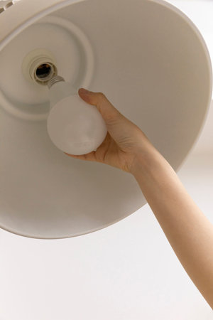 DIY interior hand motion, closeup_changing light bulbs