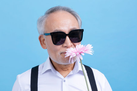 active young senior Korean Asian male holding flowers