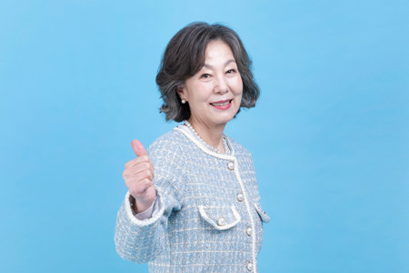 active young senior Korean Asian woman hand motionの写真素材